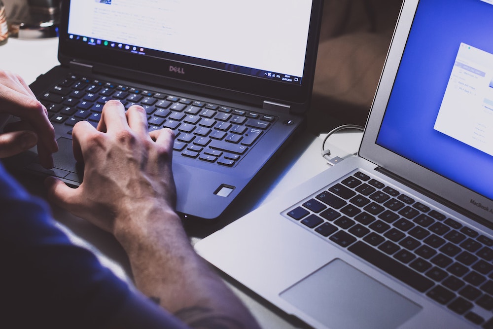 cyber liability insurance man on two laptops